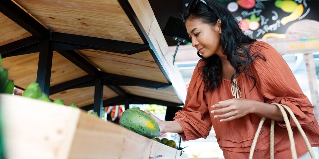 A woman buying groceries from a local street vendor.